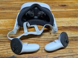 a pair of headphones and a pair of ear buds on a wooden table