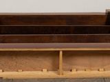 a wooden bench that is sitting on a wooden floor