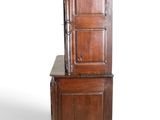 an old wooden cabinet with a door on top of it