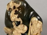 a statue of a man and a woman sitting on a rock