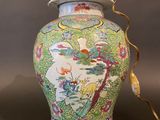 an image of a colorful vase with a lid on a table