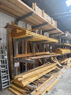 many pieces of wood stacked on the shelves in the warehouse