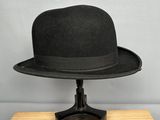 a black hat sitting on top of a wooden table