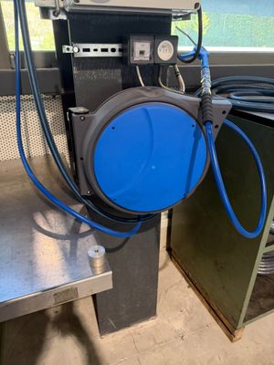 un tuyau bleu relié à un fût bleu posé sur une table
