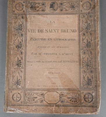an old book sitting on top of a table covered in writing
