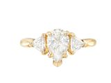 a yellow gold ring with a pear shaped diamond and three pear shaped diamonds