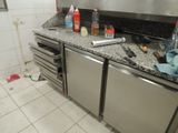 a picture of a kitchen with a lot of clutter on the counter