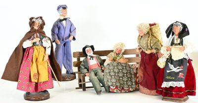five figurines of people sitting on a bench