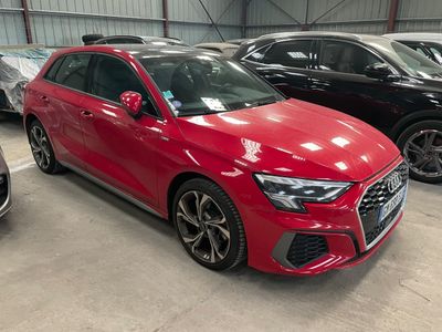 a red audi car parked in a garage next to other cars