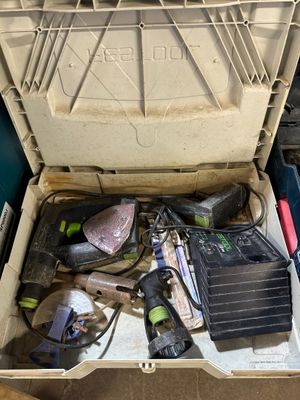a tool box with tools in it sitting on the floor