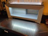 a refrigerator that has a lot of empty glasses in it