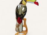 a glass toucao sitting on top of a wooden stand