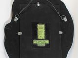 a black clock with a green letter on it