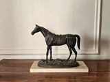 a statue of a horse that is standing on a base