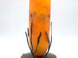 a candle that is sitting on a stand on a white surface