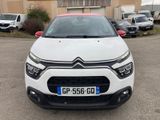 the front of a white citrole parked in a parking lot