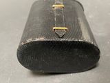 a black case with a gold handle sitting on a table
