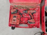 a red tool box with tools in it on the floor