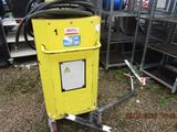 a yellow machine that is sitting in the grass