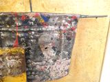 a piece of paint on the wall of a bathroom