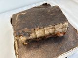 two old books stacked on top of each other on a table
