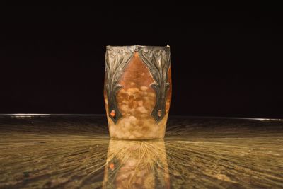 a vase that is sitting on a table with a black background