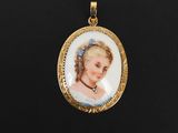 un gros plan sur la photo d'une femme figurant sur un pendentif plaqué or