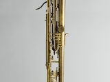 an old brass trumpet hanging from the side of a white wall