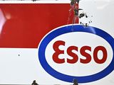 a sign that says esso on the side of a building