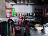 a small kitchen with a lot of clutter on the counter