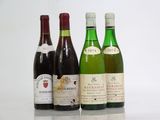 three bottles of wine are lined up on a table
