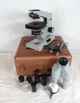 a brown suitcase with a microscope on top of it