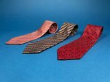 three different colored neck ties on a blue background