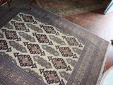 a rug on the floor in the corner of a room