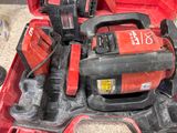 a red tool box with tools in it on the floor