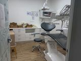 an image of a dentist ' s office with a desk and chairs