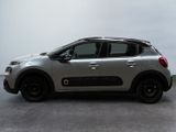 the silver car is parked on the concrete floor in the room