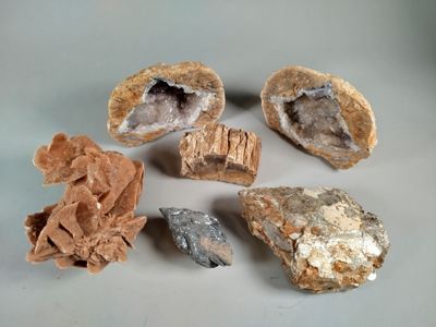 several different types of rocks on a white surface