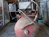 a large air compressor sitting on a pallet in a warehouse