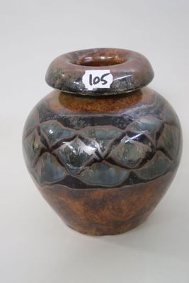 a brown and black vase with a tag on it