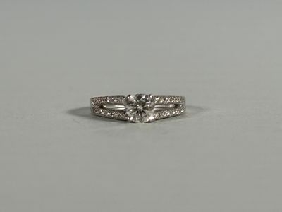 an engagement ring with a diamond set in the middle of it