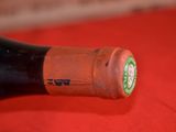 a bottle of wine that is open on a table