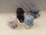 three balls of yarn sitting on a bed next to each other