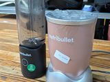 a blender sitting on a wooden table next to a blender