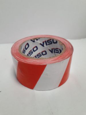 un rouleau de ruban adhésif rouge et blanc sur une surface blanche