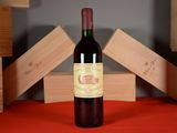a bottle of red wine sitting on a table