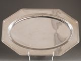 a silver plate on a stand on a table