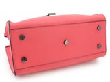 the pink purse is sitting on a white surface with a white background