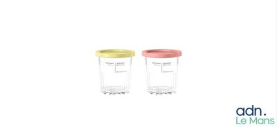 two blenders sitting next to each other on a white surface