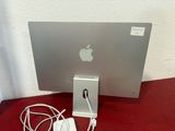 a silver apple computer sitting on a red table
